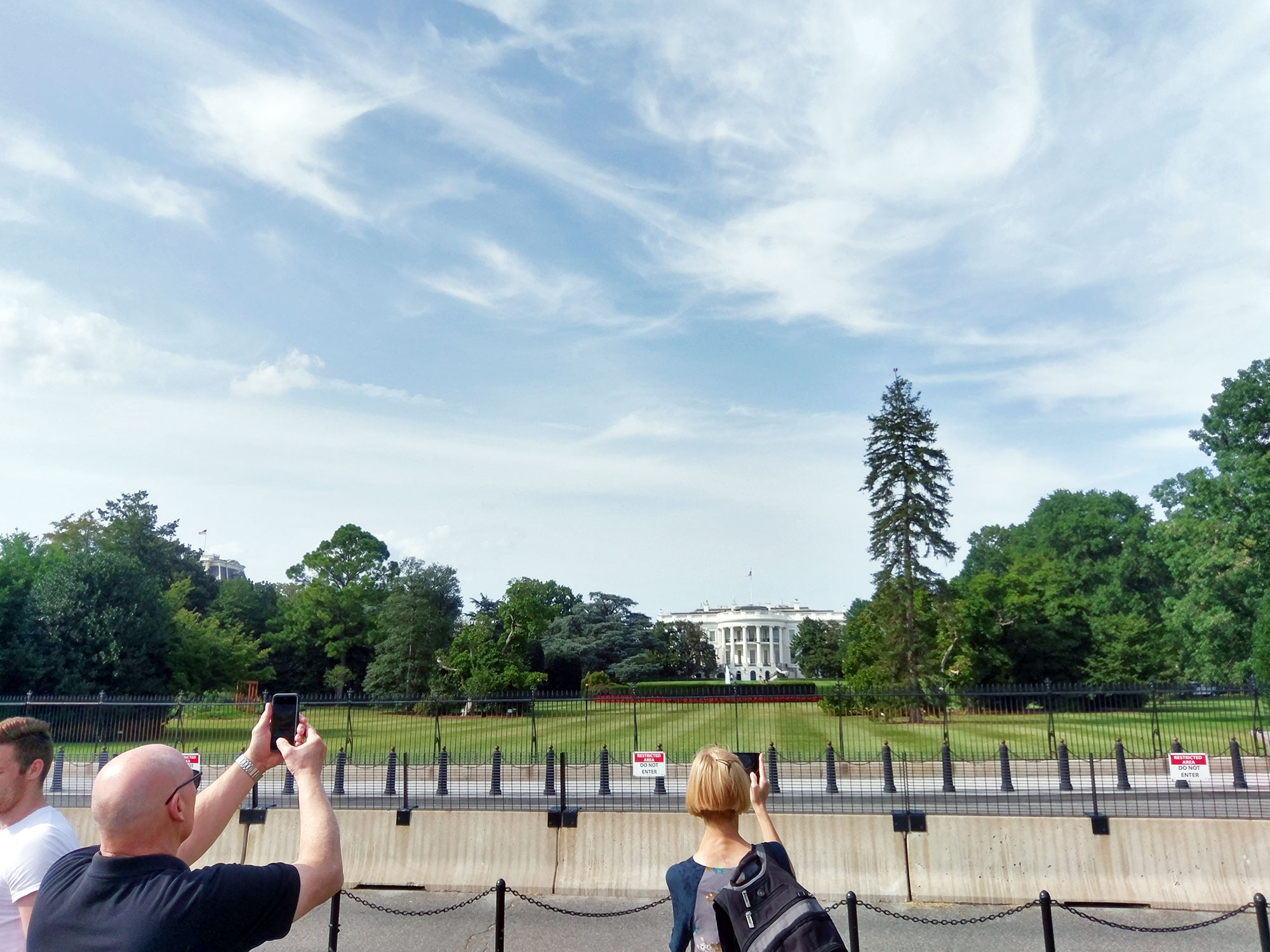 Tourists taking pictures of the White House in Washington D.C.