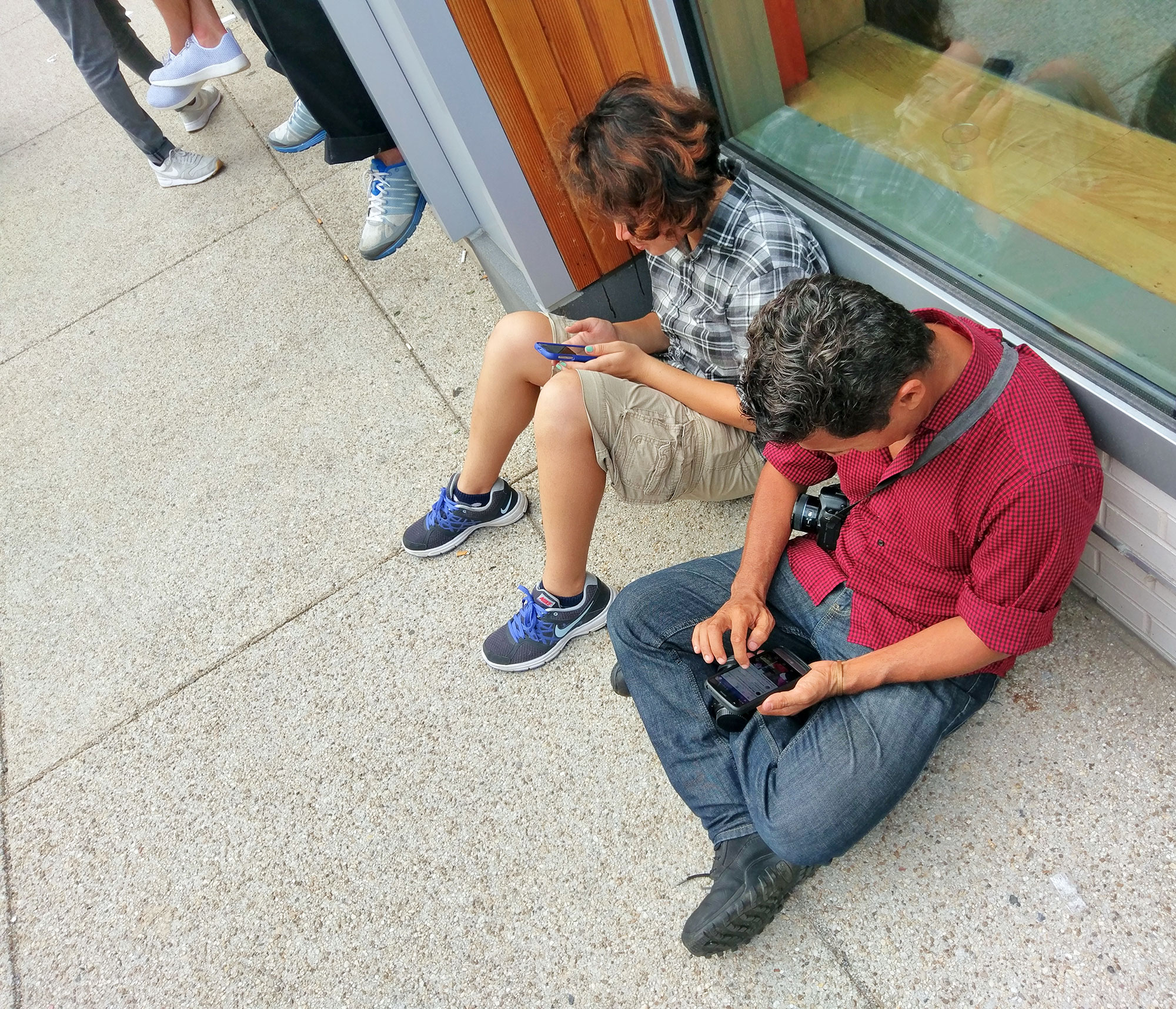 Festival-goers busy on their phones on H Street.